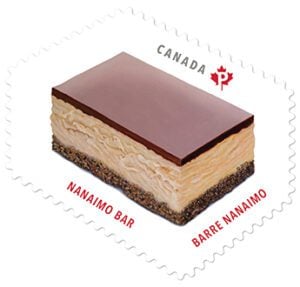 A stamp featuring a Nanaimo Bar. The bar has three layers, a crumbly base, a large amount of custard filling and a chocolate top. The stamp reads "CANADA" at the top with the Canada Post logo, and "Nanaimo Bar Barre Nanaimo" along the bottom.